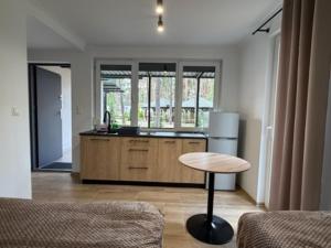 a kitchen with a counter and a table in a room at Hotel Eljot in Sielpia Wielka