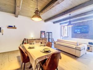 a living room with a table and a couch at Apartment Novecento by Interhome in Monterotondo