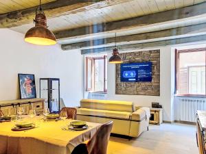 a living room with a table and a couch at Apartment Novecento by Interhome in Monterotondo +15 photos