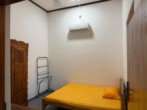 a bedroom with a bed and a air conditioner on the wall at Stay Home Arugambay in Arugam Bay