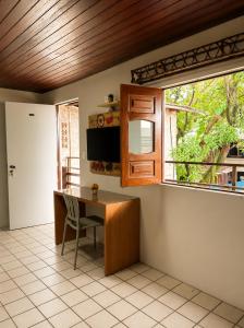 a kitchen with a desk and a window at Hotel Pousada Casuarinas in Recife