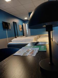 a room with a desk with a lamp and a bed at Double Room 9 in Saeby in Sæby
