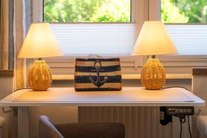 two lamps on a table with a bag on it at Ferienhaus Sonneneck in Kluis +30 photos