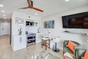 a kitchen with a living room with a couch and a table at Unwind by the Beach | Pool and Oceanfront View in Corpus Christi