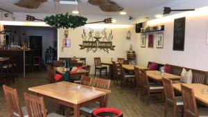 a dining room with wooden tables and chairs in a restaurant at Gemütliche Apartments in Bendorf