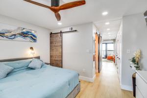 a bedroom with a blue bed and a ceiling fan at Unwind by the Beach | Pool and Oceanfront View in Corpus Christi +16 photos