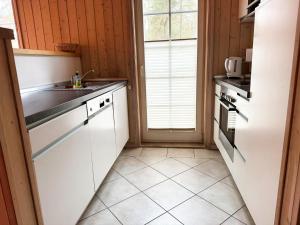 a kitchen with white cabinets and a sink at Seebrise Baabe in Baabe