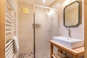a bathroom with a sink and a shower at Appartements Stockinger A1 in Grossarl +22 photos