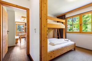 a bedroom with a bunk bed in a room at Appartements Stockinger A1 in Grossarl