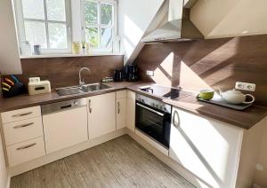 a kitchen with a sink and a stove at Alte Schule Breese in Dannenberg