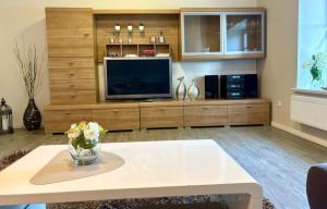 a living room with a large entertainment center with a tv at Alte Schule Breese in Dannenberg