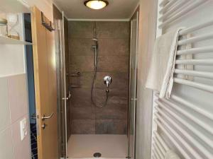 a shower in a bathroom with a glass door at Moderne Ruheoase Allgäu in Oberreute +22 photos