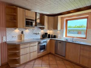 a kitchen with wooden cabinets and a window at Theodor Heuss in Westerland +7 photos