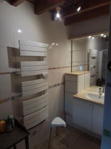 a bathroom with a sink and a mirror and a stool at Gite de Cerney in Marcilly-Ogny +6 photos