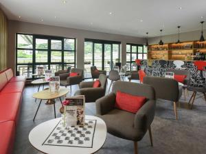 ein Wartezimmer mit Sofas, Stühlen und Tischen in der Unterkunft ibis Dinant Centre in Dinant