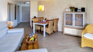 a living room with a table and a couch at Apartment Seeterrasse in Schalkenmehren