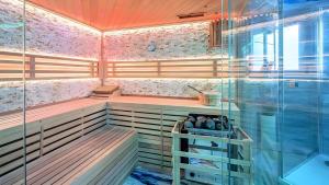 a bathroom with a sauna with a glass shower at Apartment Seeterrasse in Schalkenmehren