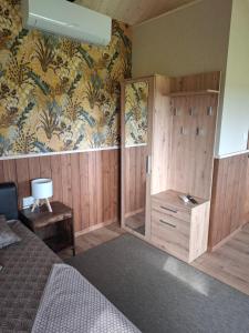 a bedroom with a bed and a floral wallpaper at Pärna Muhu Island 2 in Paenase +10 photos