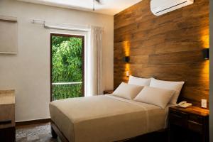 a bedroom with a large bed and a window at Gran Vila Nai Boutique Hotel in Guadalajara