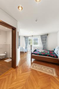 a bedroom with a bed in the middle of a room at Pensiunea la Tăuț in Călineşti +48 photos