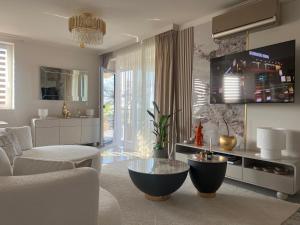 a living room with a couch and a table at Louise Luxury - free parking in Nyíregyháza