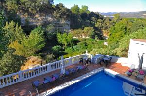 a pool with chairs and tables on a balcony at Nueva Villa Ignacia in Arriate