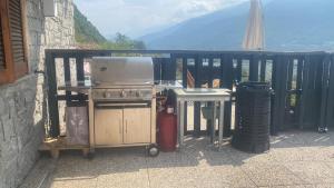 a stove and a table on a balcony at casa vacanze LA CA Del Cunfec in Sondrio +27 photos