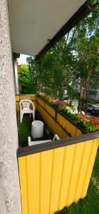 a balcony with a bench and flowers in a yard at Spacious apartment with balcony in Tallinn