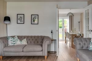 a living room with a couch and a table at Recently Refurbished House Sleeps 5 near Stadiums in Liverpool +22 photos