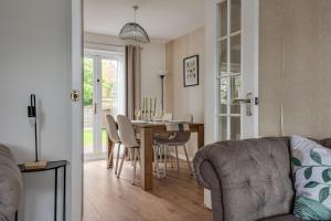 a dining room and living room with a table and chairs at Recently Refurbished House Sleeps 5 near Stadiums in Liverpool