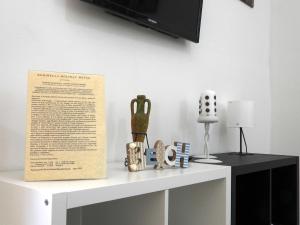 a white cabinet with a tv on top of it at Doribella Holiday House in Pollina