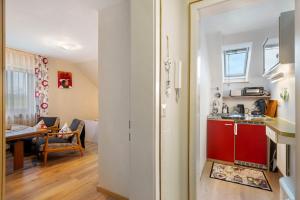 a kitchen and a living room with a table at Apartment Abendrot in Freiamt