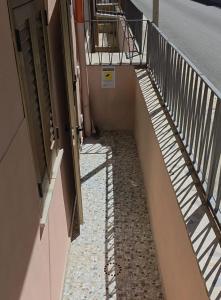an empty hallway with stairs in a building at Doribella Holiday House in Pollina
