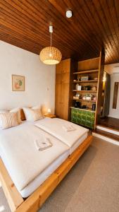 a bedroom with a large bed with a wooden ceiling at Mountain View Room mit sonnigem Wintergarten in Dietmannsdorf bei Trieben
