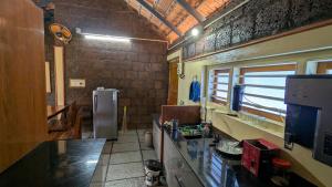 a kitchen with a counter and a refrigerator in it at Kabani Villa in Mananthavady