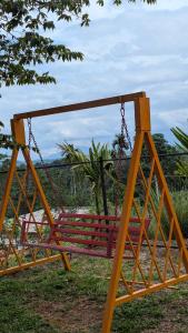 a swing in a park with a tree at Kabani Villa in Mananthavady
