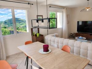 a living room with a table and a couch at Le balcon de Compostelle in Espaly-Saint-Marcel