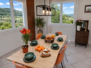 a dining room with a table with food on it at Le balcon de Compostelle in Espaly-Saint-Marcel
