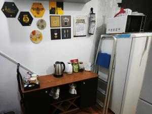a kitchen with a counter next to a refrigerator at Cantinho da Jessi in São Vicente