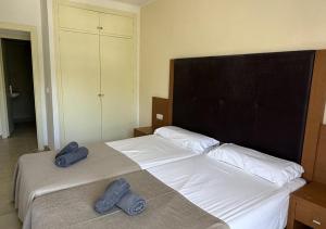 a bedroom with two beds with towels on them at El Cortijo Escana in Es Cana +27 photos