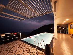 a swimming pool on top of a house at Valley View Villa Wai in Wai