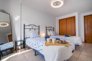 a bedroom with two beds and a table with a plate of food at CASA VARGAS-TENERIFE in Los Cristianos