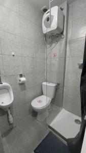a bathroom with a toilet and a sink at Cozy studio apartment with 2 beds and kitchen in Audun-le-Tiche