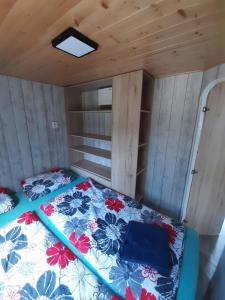 a bed in the inside of a tiny house at Mobilheim na louce Farma Simandl in Jiratice +15 photos