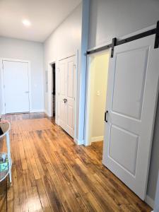 an open door in a room with wooden floors at Historic Federal Hill 1Br Loft apt with onsite Gym and Barbershop in Providence