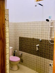 a bathroom with a toilet and a shower at Stay Home Arugambay in Arugam Bay