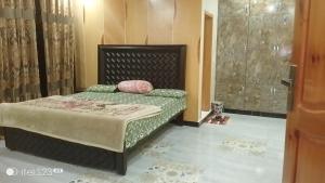 a bedroom with a bed and a shower at BHURBAN MOUNTAIN VIEW APARTMENTs in Murree