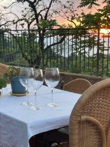 a table with three wine glasses sitting on it at Sea View Private Villa in Batumi