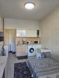 a kitchen with a washing machine and a table at relax in Plovdiv