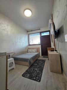 a bedroom with a bed and a large window at relax in Plovdiv